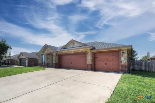 ranch-style home featuring a garage and a front yard