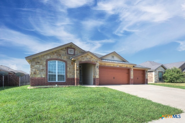 view of front facade featuring a garage and a front yard