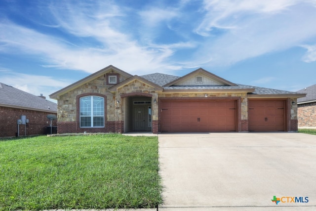 view of front of home with a garage and a front yard