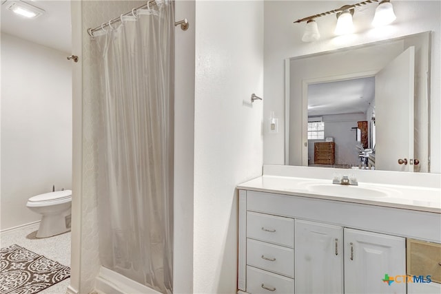 bathroom featuring walk in shower, vanity, and toilet