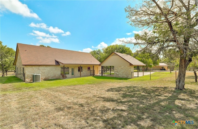 rear view of house featuring a lawn