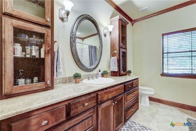 bathroom with vanity, tile patterned floors, toilet, and crown molding