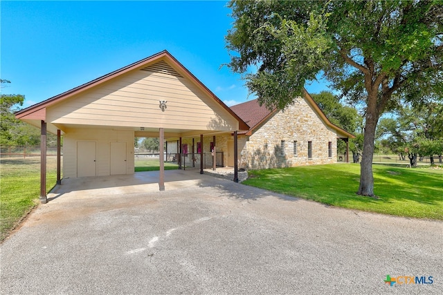 view of front of property with a front lawn and a carport