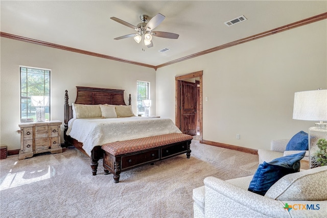 carpeted bedroom featuring ornamental molding and ceiling fan