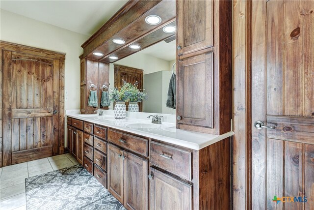 bathroom with tile patterned flooring and vanity