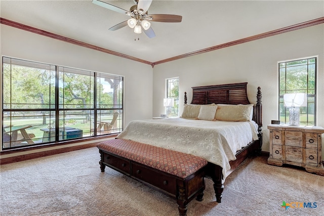 carpeted bedroom with ornamental molding, multiple windows, and ceiling fan