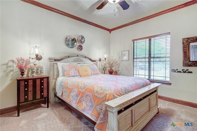 carpeted bedroom with ceiling fan and ornamental molding