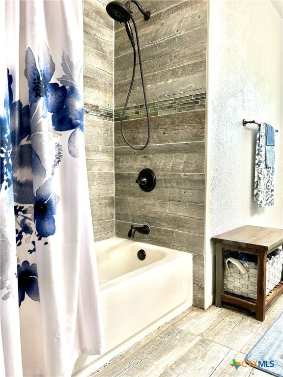 bathroom with shower / tub combo and hardwood / wood-style flooring