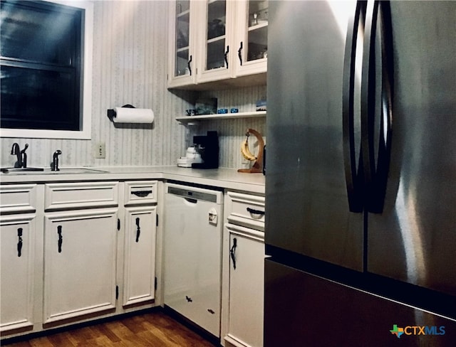 kitchen featuring white cabinets, dark hardwood / wood-style flooring, sink, and appliances with stainless steel finishes