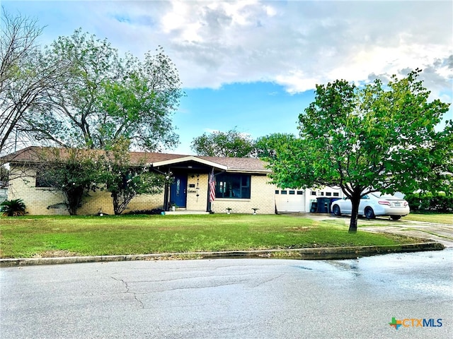 single story home with a front yard and a garage