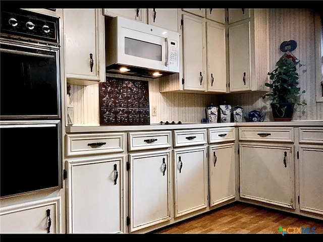 kitchen with light wood-type flooring and double oven