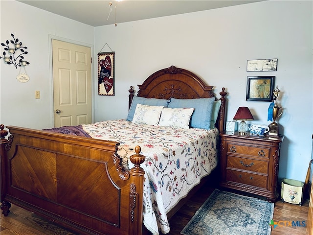 bedroom with dark wood-type flooring