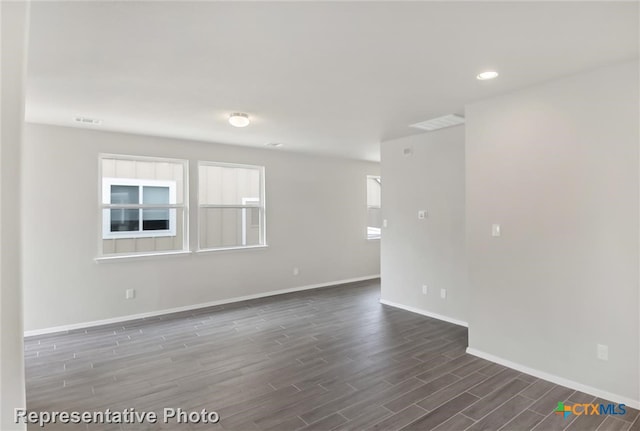 spare room with dark wood-type flooring