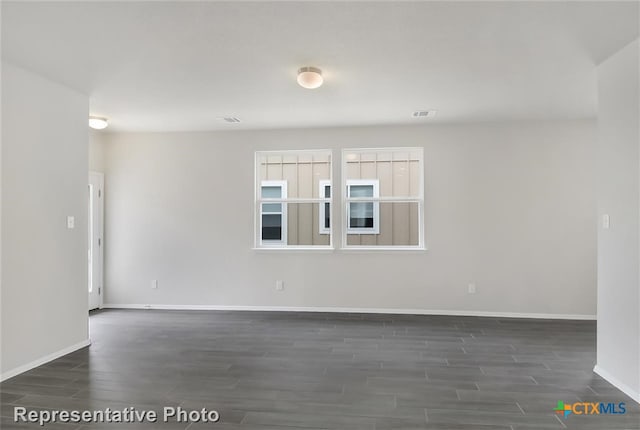 spare room with dark wood-type flooring