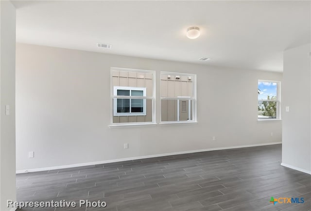 unfurnished room with dark hardwood / wood-style flooring