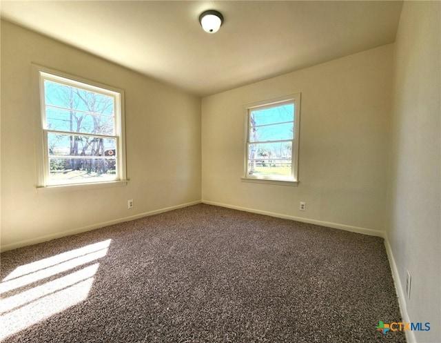 carpeted empty room with baseboards