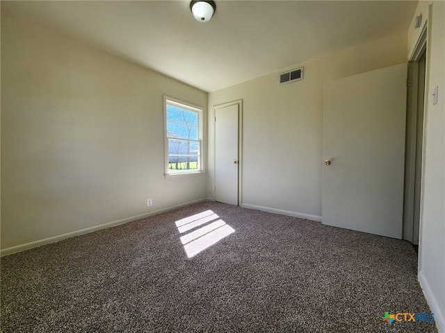 unfurnished bedroom featuring visible vents, baseboards, and carpet floors