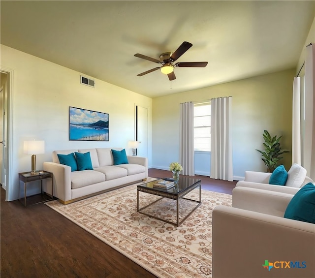 living room featuring visible vents, ceiling fan, and dark wood-style flooring