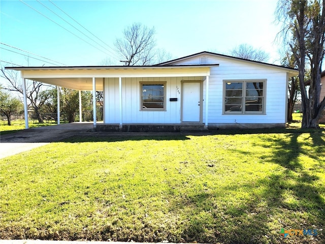 view of front facade with an attached carport, aphalt driveway, board and batten siding, and a front yard