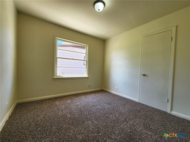 carpeted empty room with baseboards