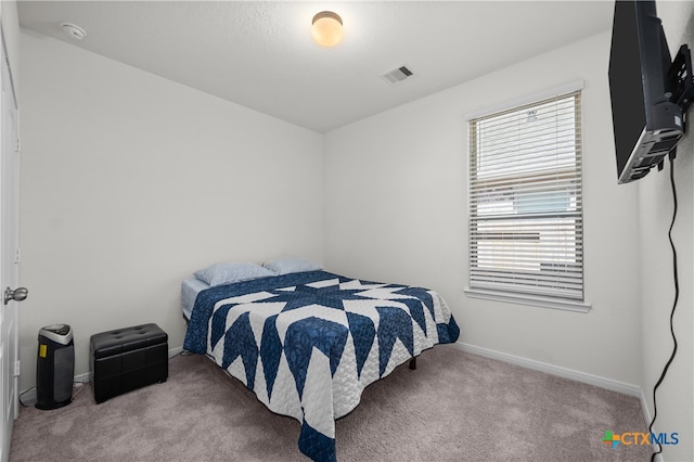 bedroom with light colored carpet