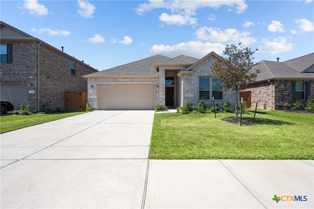 view of front of house with a garage and a front lawn