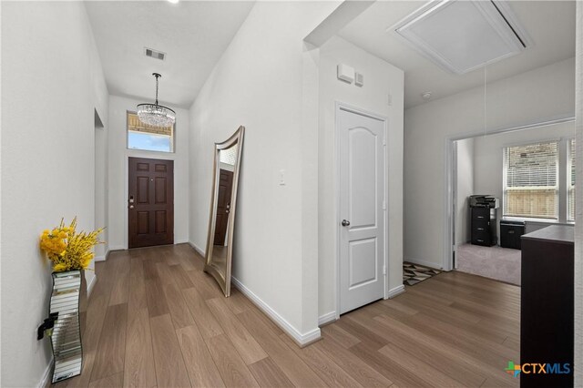 7703 Coral Key Dr, Northwest Harris, TX 77433 - hall with attic access, light wood-style floors, and baseboards