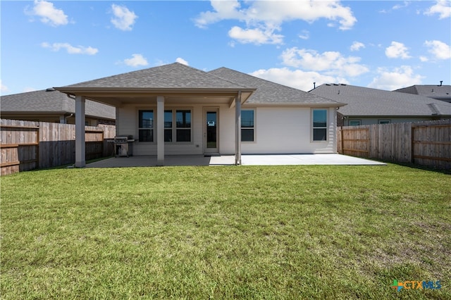 back of property featuring a lawn and a patio