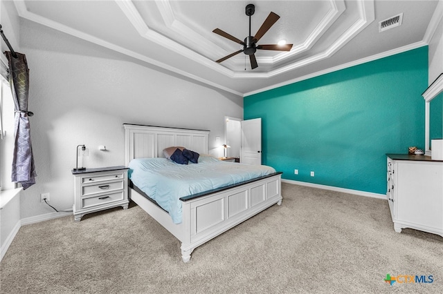 bedroom featuring a tray ceiling, ceiling fan, light colored carpet, and ornamental molding