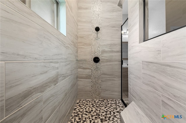 bathroom with tiled shower