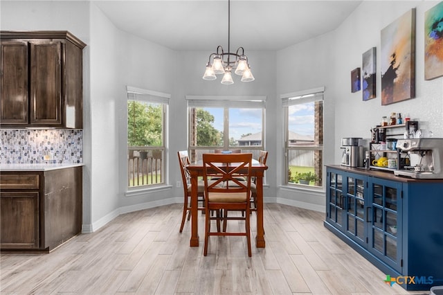 dining room featuring a notable chandelier and light hardwood / wood-style flooring