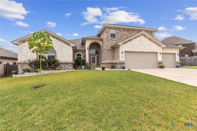 view of front of home with a front yard and a garage