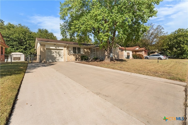 ranch-style home featuring a garage and a front yard