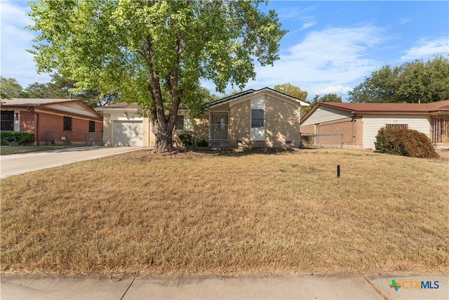 ranch-style home with a front lawn and a garage