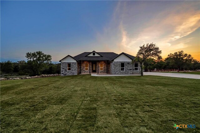 113 Cobblestone Ln, Burnet, TX 78611 - view of front facade with stone siding and a front lawn