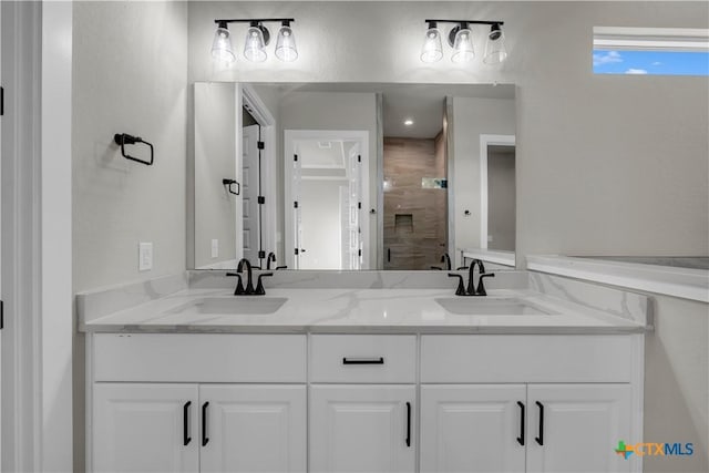 113 Cobblestone Ln, Burnet, TX 78611 - bathroom with double vanity, a shower stall, and a sink