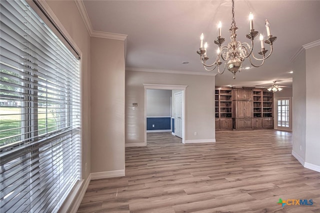 unfurnished living room featuring wood-type flooring, ceiling fan with notable chandelier, and ornamental molding