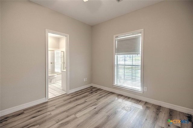 unfurnished room with light wood-type flooring