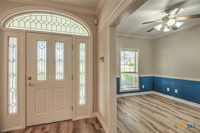 foyer featuring light hardwood / wood-style flooring, ceiling fan, and crown molding