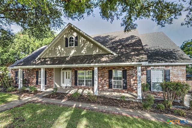 view of front of home featuring a front lawn and a porch