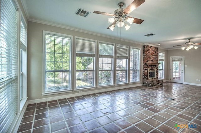 unfurnished living room featuring ceiling fan, crown molding, and a brick fireplace