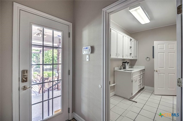 laundry area with sink and light tile patterned flooring