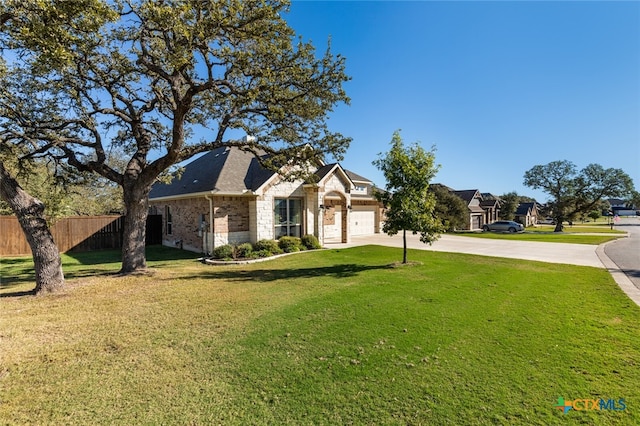 view of front of home with a front yard and a garage