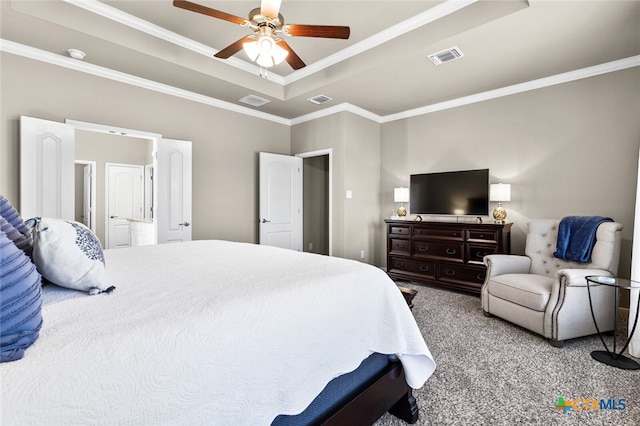 carpeted bedroom featuring a raised ceiling, ceiling fan, and ornamental molding