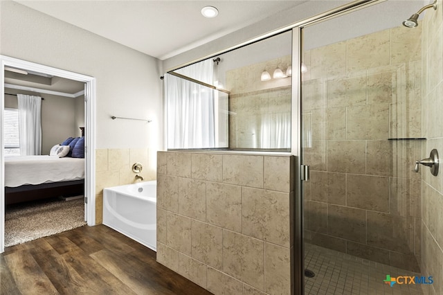 bathroom with separate shower and tub, crown molding, and hardwood / wood-style flooring