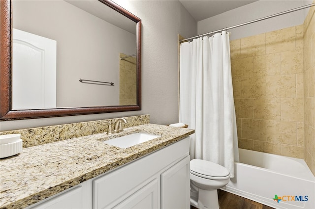 full bathroom featuring shower / bath combination with curtain, vanity, wood-type flooring, and toilet