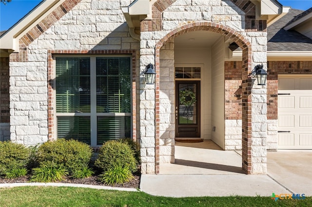 view of exterior entry featuring a garage