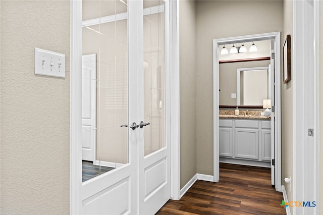 hallway featuring sink and dark wood-type flooring