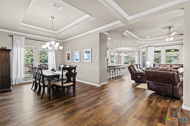 dining room featuring a healthy amount of sunlight, dark hardwood / wood-style flooring, and crown molding