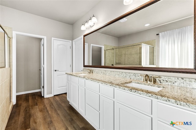 bathroom featuring vanity, hardwood / wood-style flooring, and walk in shower